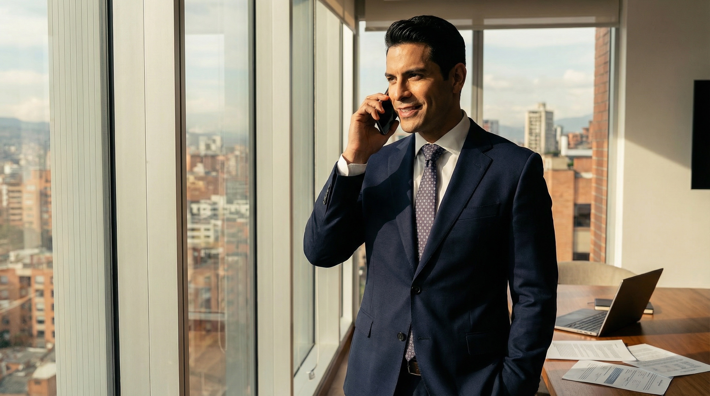 Alejo in his apartment, phone to his ear, watching the city through floor-to-ceiling windows. His exile hasn't diminished his ambition. If anything, it's sharpened it.